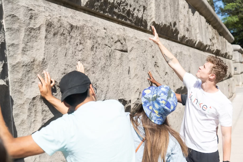 A tour guide pointing at a wall